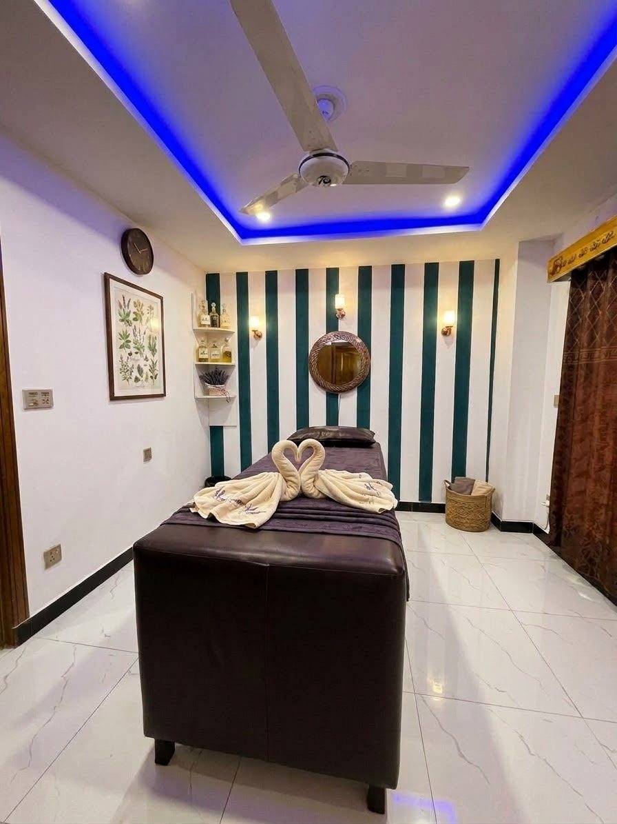 Zest treatment room with blue ceiling light and towel swans on the bed