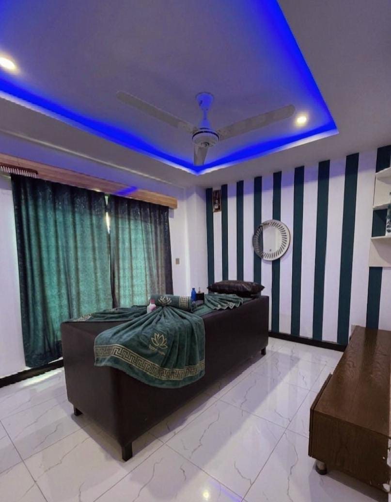 Room with teal curtains and lotus towels